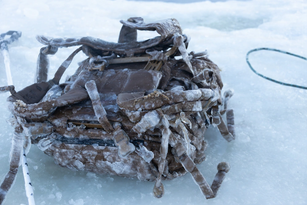 Frozen rucksack covered in ice